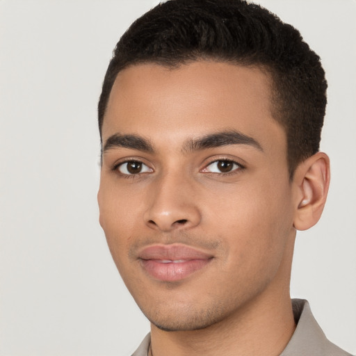 Joyful latino young-adult male with short  brown hair and brown eyes