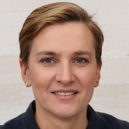 Joyful white adult female with short  brown hair and grey eyes