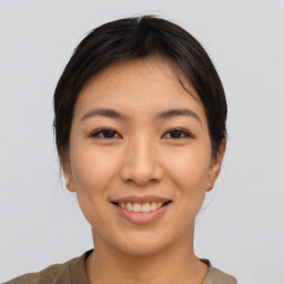 Joyful asian young-adult female with short  brown hair and brown eyes