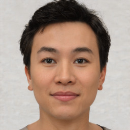 Joyful asian young-adult male with short  brown hair and brown eyes