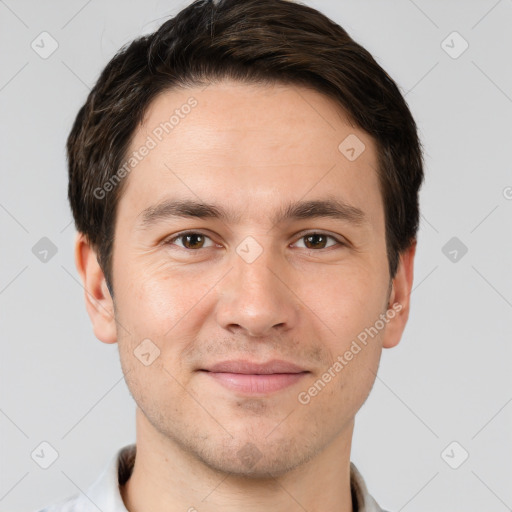 Joyful white young-adult male with short  brown hair and grey eyes