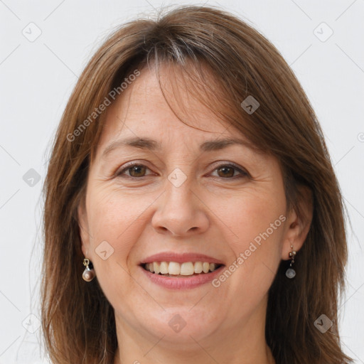 Joyful white adult female with long  brown hair and grey eyes