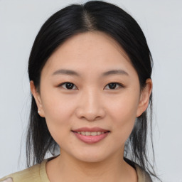 Joyful asian young-adult female with medium  brown hair and brown eyes