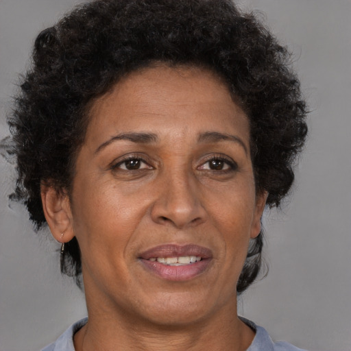 Joyful black adult female with short  brown hair and brown eyes