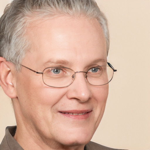 Joyful white middle-aged male with short  gray hair and blue eyes