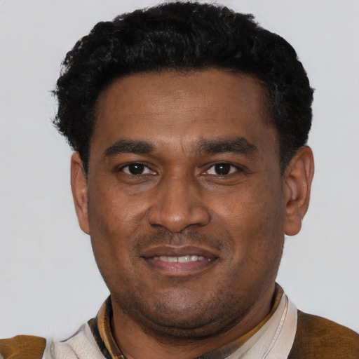 Joyful latino adult male with short  black hair and brown eyes