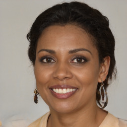 Joyful black young-adult female with medium  brown hair and brown eyes