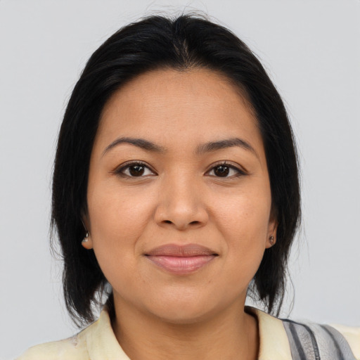 Joyful latino young-adult female with medium  brown hair and brown eyes