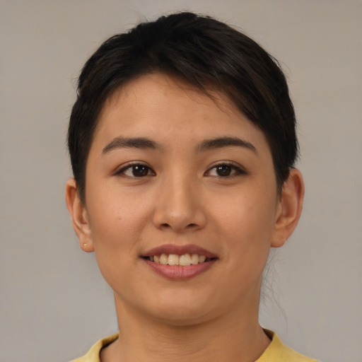 Joyful asian young-adult female with short  brown hair and brown eyes