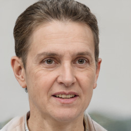 Joyful white adult male with short  brown hair and grey eyes