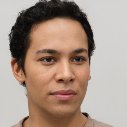 Joyful latino young-adult male with short  brown hair and brown eyes