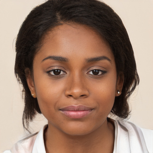 Joyful black young-adult female with medium  brown hair and brown eyes