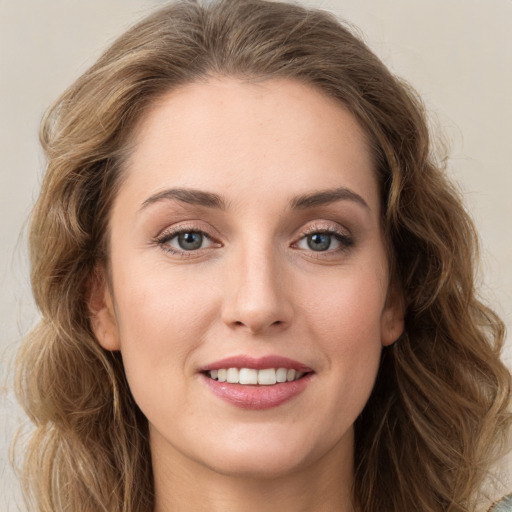 Joyful white young-adult female with long  brown hair and green eyes