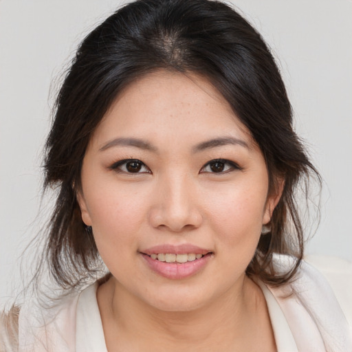 Joyful asian young-adult female with medium  brown hair and brown eyes