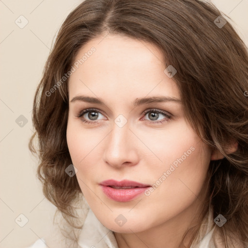 Joyful white young-adult female with medium  brown hair and green eyes