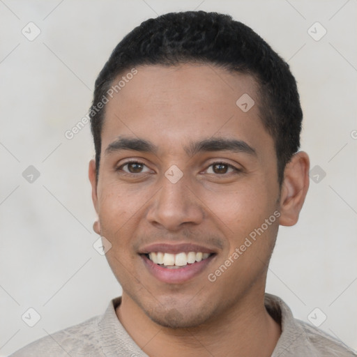 Joyful latino young-adult male with short  black hair and brown eyes