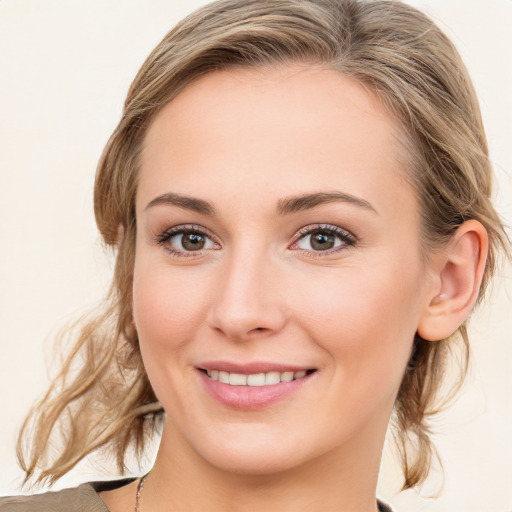 Joyful white young-adult female with medium  brown hair and blue eyes