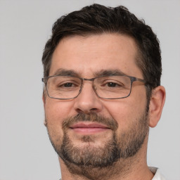 Joyful white adult male with short  brown hair and brown eyes