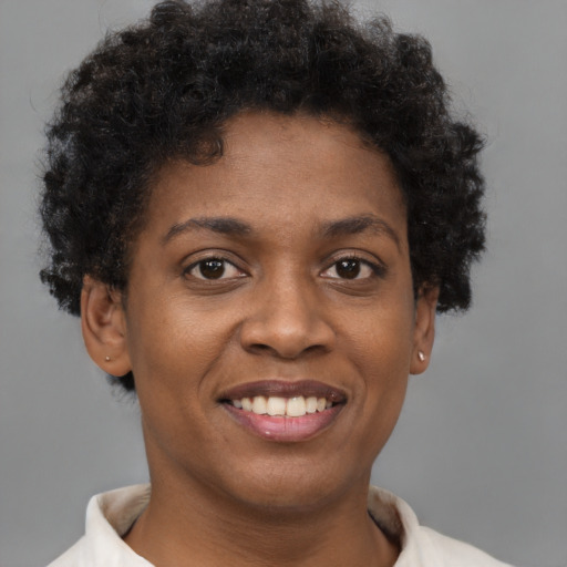 Joyful black young-adult female with short  brown hair and brown eyes