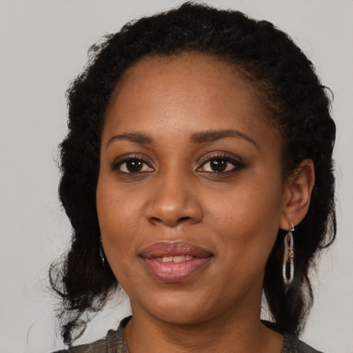 Joyful black young-adult female with medium  brown hair and brown eyes