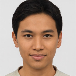 Joyful asian young-adult male with short  black hair and brown eyes