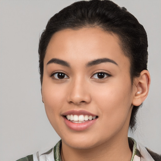 Joyful latino young-adult female with medium  black hair and brown eyes