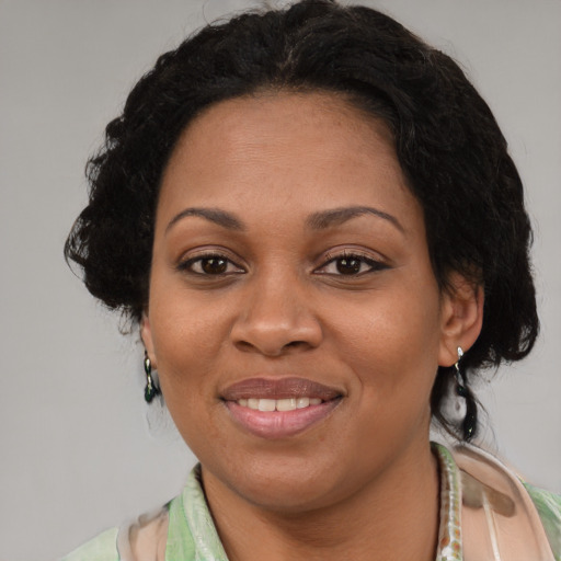 Joyful latino adult female with medium  brown hair and brown eyes