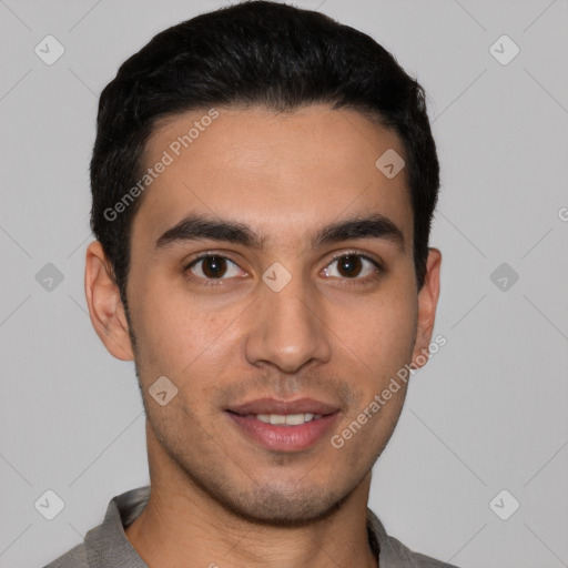 Joyful white young-adult male with short  black hair and brown eyes