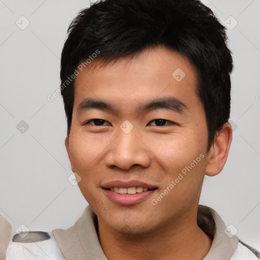 Joyful asian young-adult male with short  black hair and brown eyes