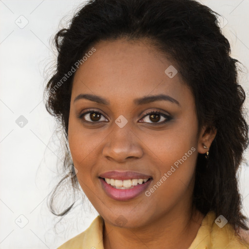 Joyful black young-adult female with long  brown hair and brown eyes