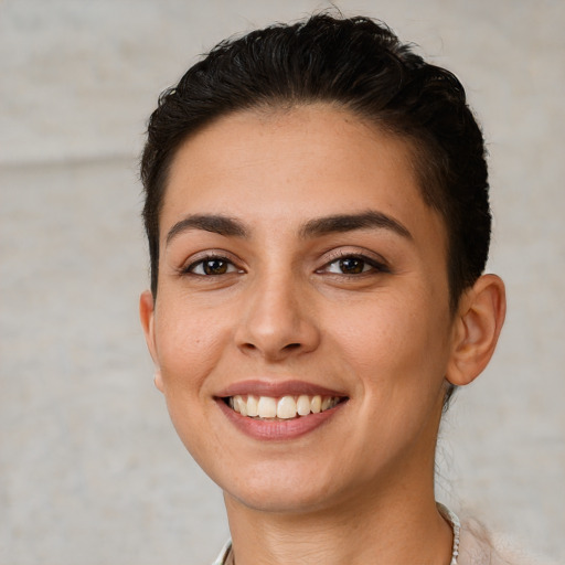 Joyful white young-adult female with short  brown hair and brown eyes