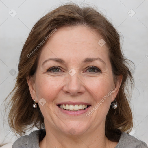 Joyful white adult female with medium  brown hair and grey eyes