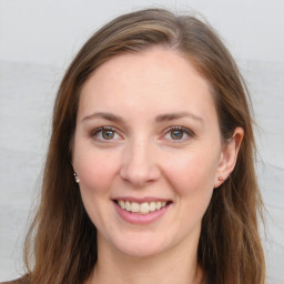 Joyful white young-adult female with long  brown hair and grey eyes