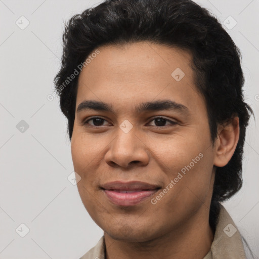 Joyful latino young-adult male with short  brown hair and brown eyes