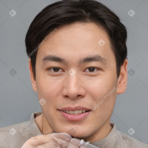 Joyful asian young-adult male with short  brown hair and brown eyes