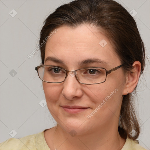 Joyful white adult female with medium  brown hair and brown eyes