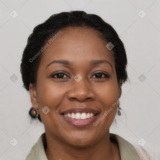 Joyful black adult female with medium  brown hair and brown eyes