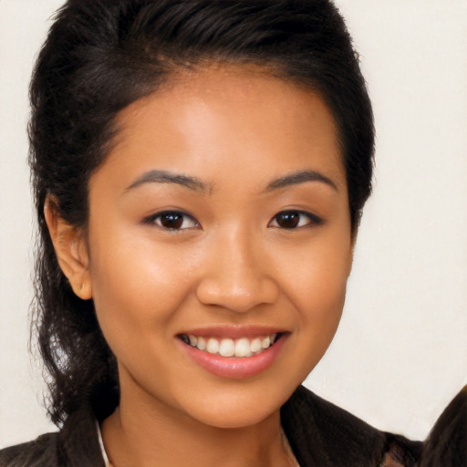 Joyful latino young-adult female with long  brown hair and brown eyes