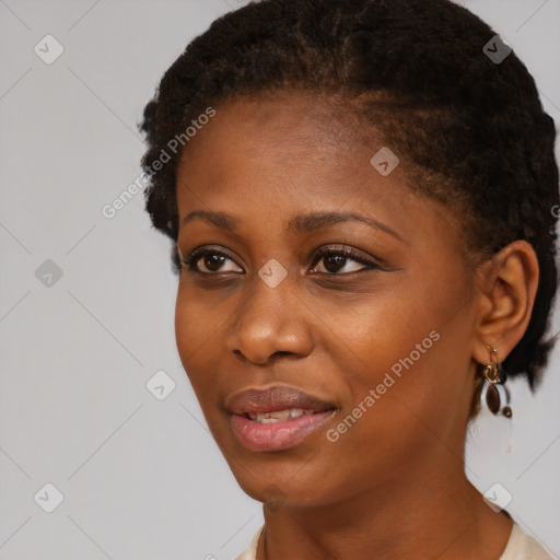 Joyful black young-adult female with short  black hair and brown eyes