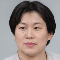 Joyful asian adult female with short  brown hair and brown eyes