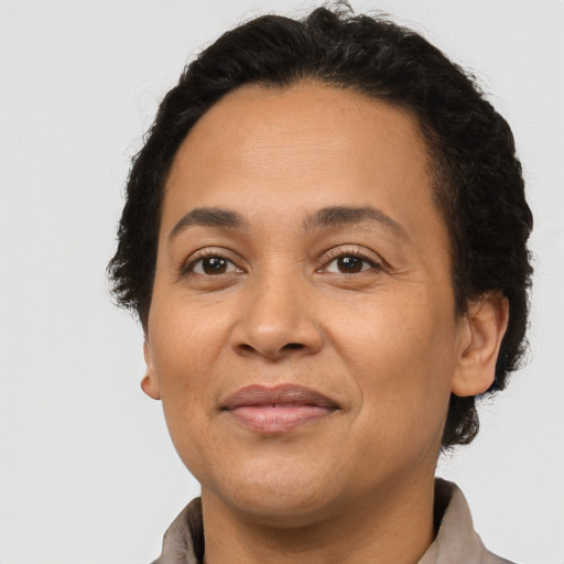 Joyful latino adult female with short  brown hair and brown eyes