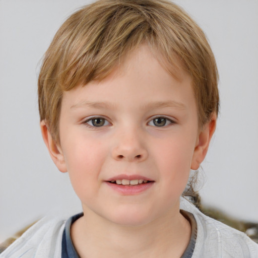 Joyful white child male with short  brown hair and blue eyes