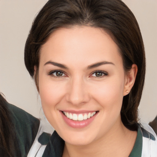 Joyful white young-adult female with medium  brown hair and brown eyes