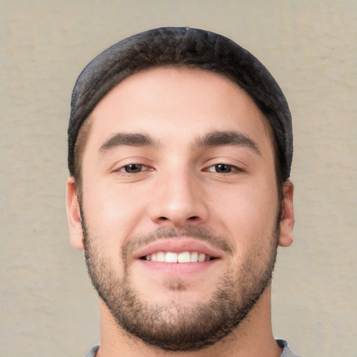 Joyful white young-adult male with short  black hair and brown eyes