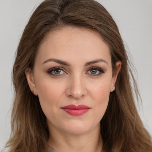 Joyful white young-adult female with long  brown hair and brown eyes