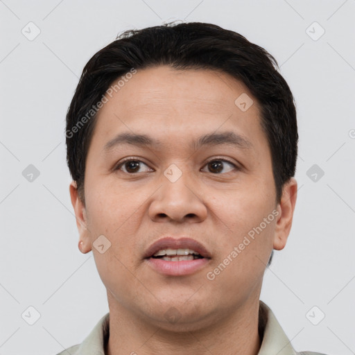 Joyful white young-adult male with short  black hair and brown eyes