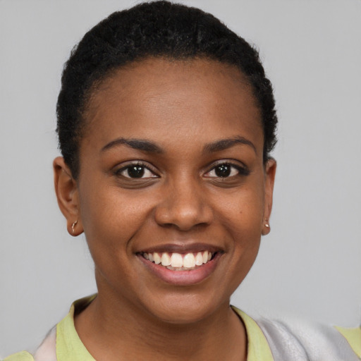 Joyful black young-adult female with short  brown hair and brown eyes