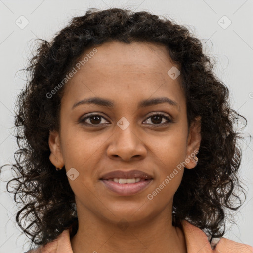 Joyful black young-adult female with long  brown hair and brown eyes