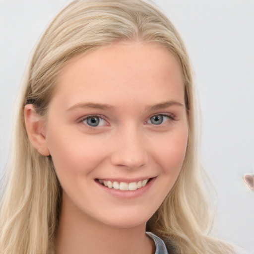 Joyful white young-adult female with long  blond hair and blue eyes