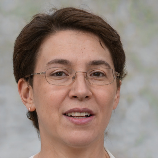 Joyful white adult female with medium  brown hair and green eyes